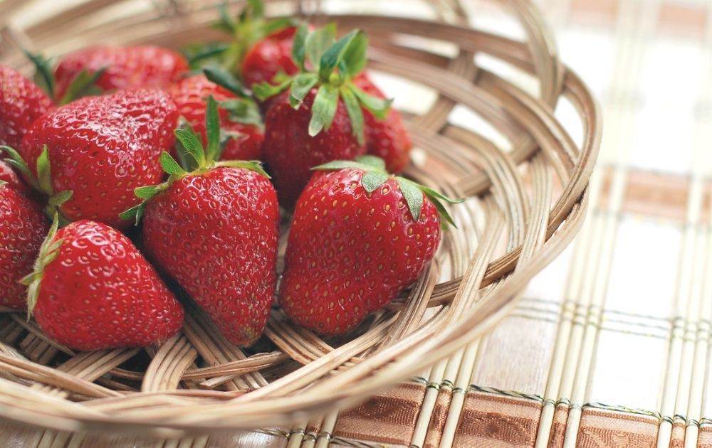 A basket of strawberries on a table